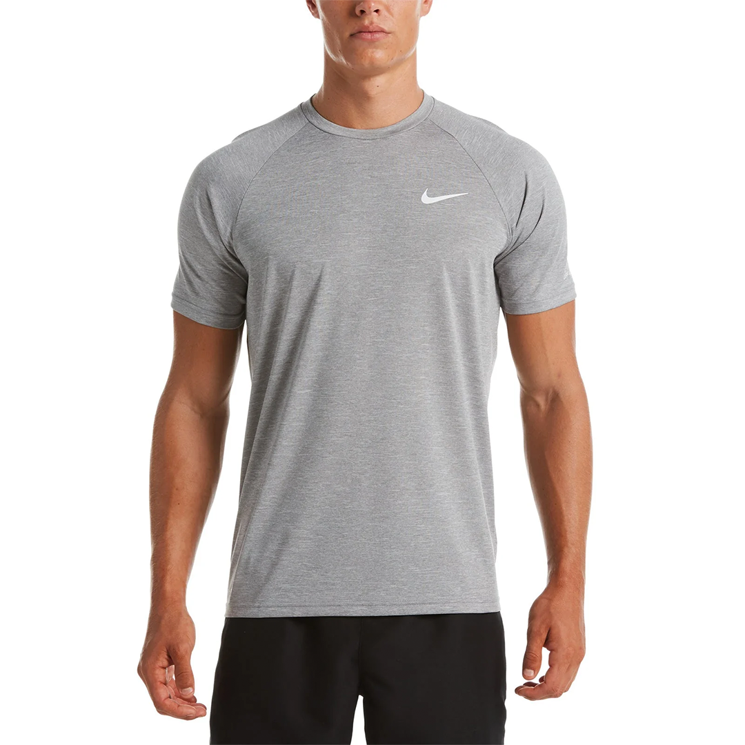 Man wearing a gray Nike athletic shirt on a white background