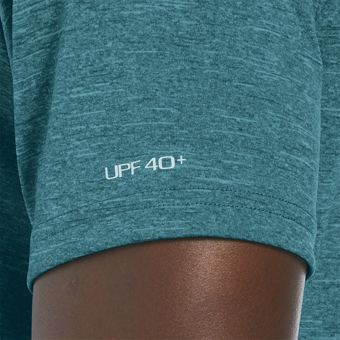 Teal athletic shirt with 'UPF 40+' text on a person wearing it.