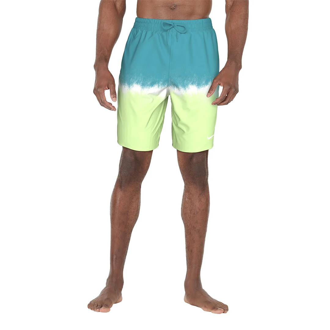 Man wearing a two-tone swim shorts with blue and green gradient on a white background
