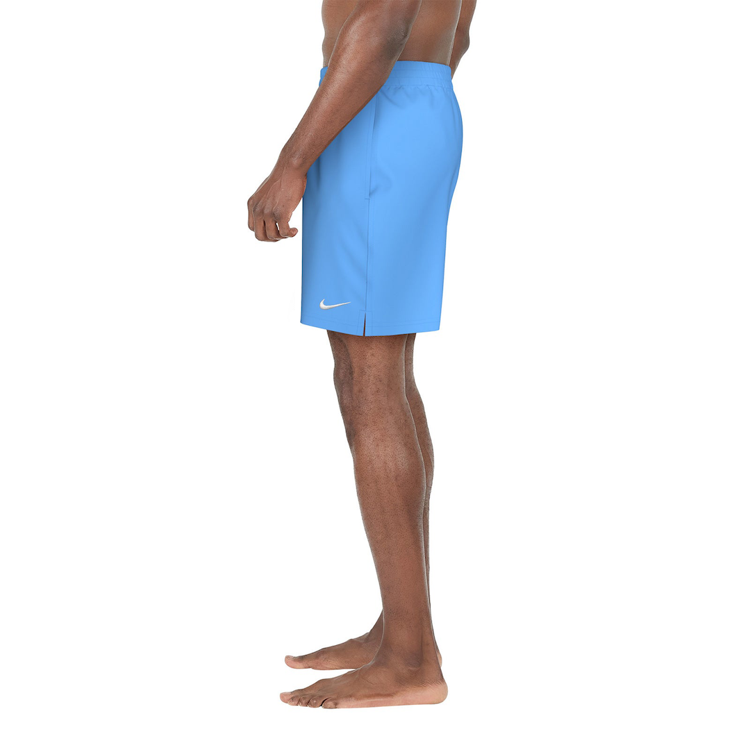 Person wearing blue Nike shorts on a white background