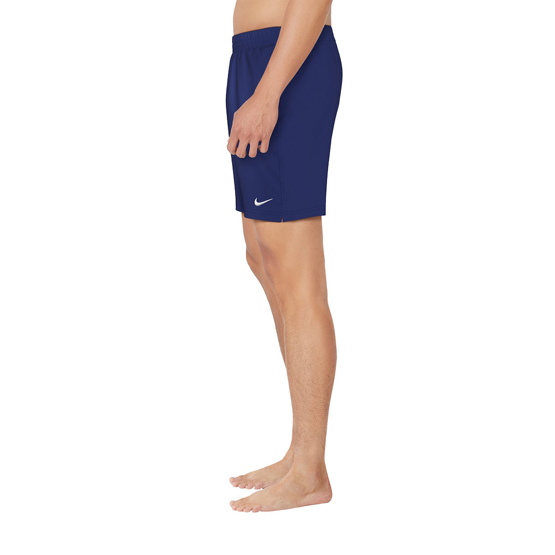 Person wearing navy blue shorts with a white logo on a white background