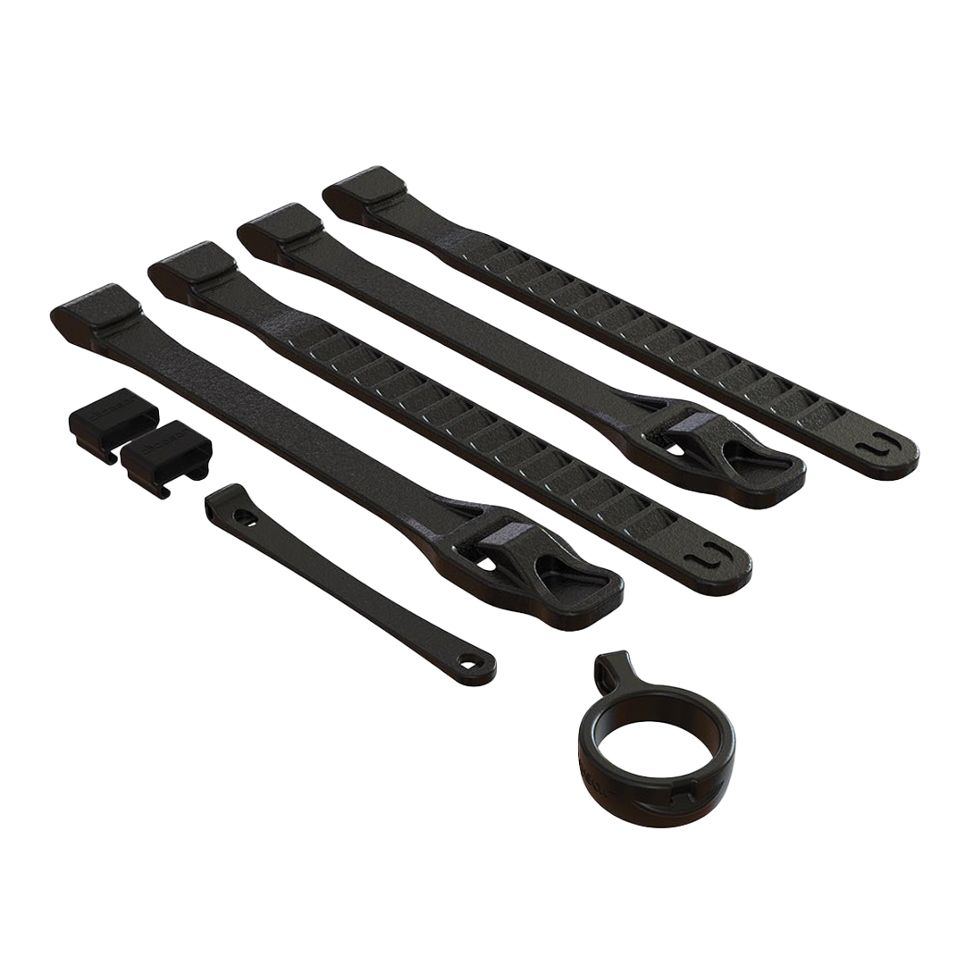 Set of black cable ties and a clip on a white background