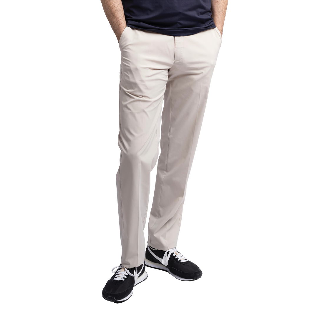 Person wearing light gray pants and black sneakers on a white background