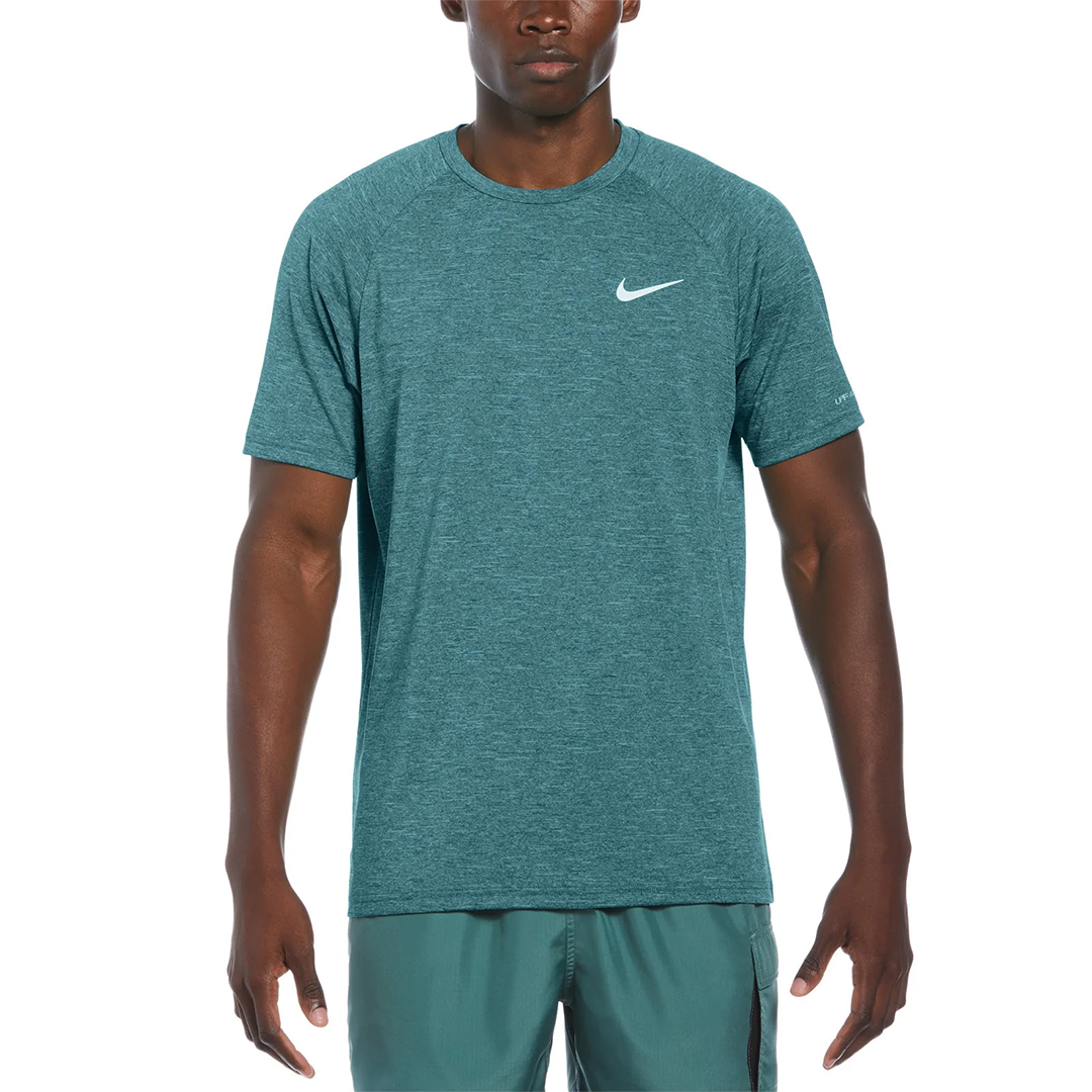 Man wearing a teal Nike t-shirt on a white background