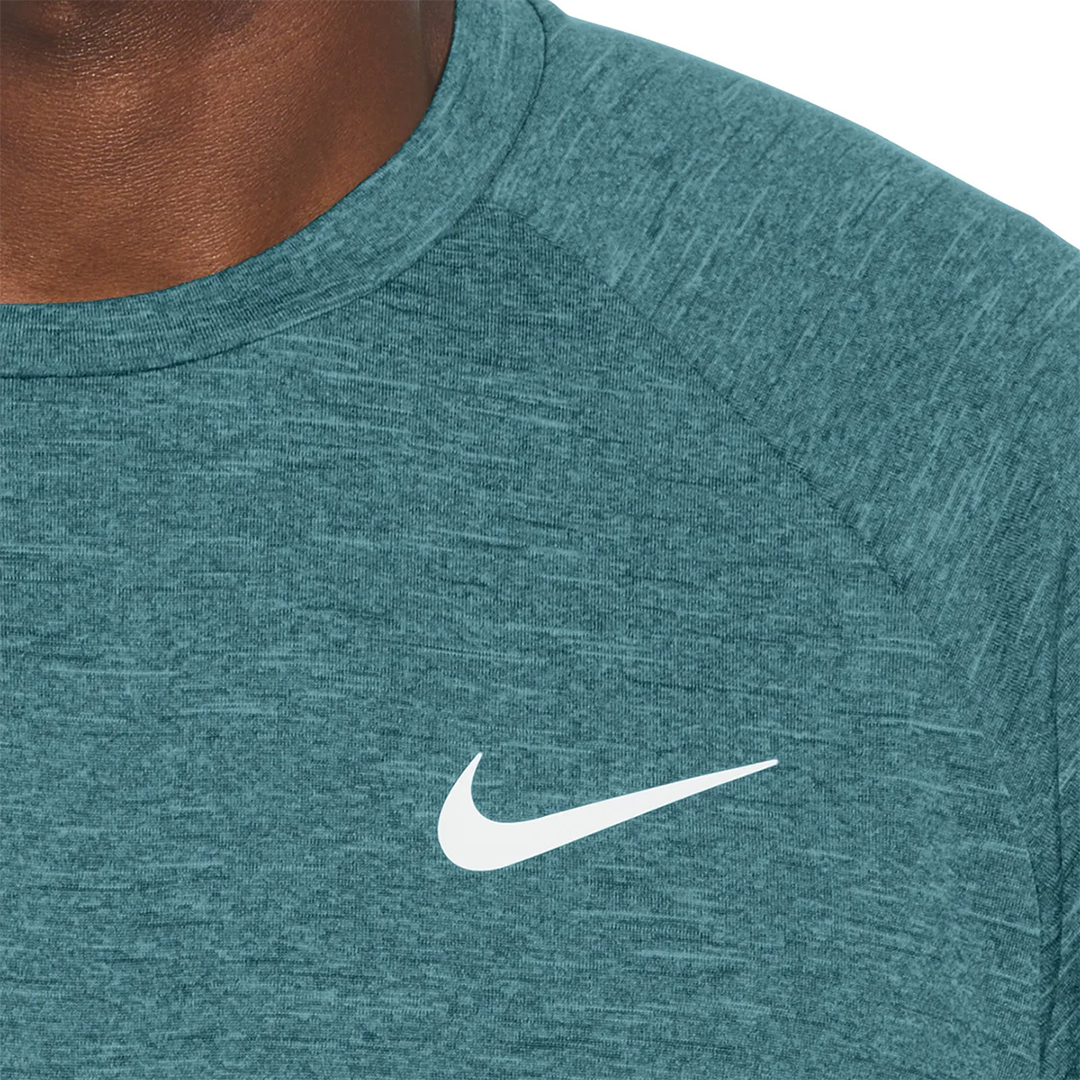 Teal athletic shirt with Nike logo on a white background