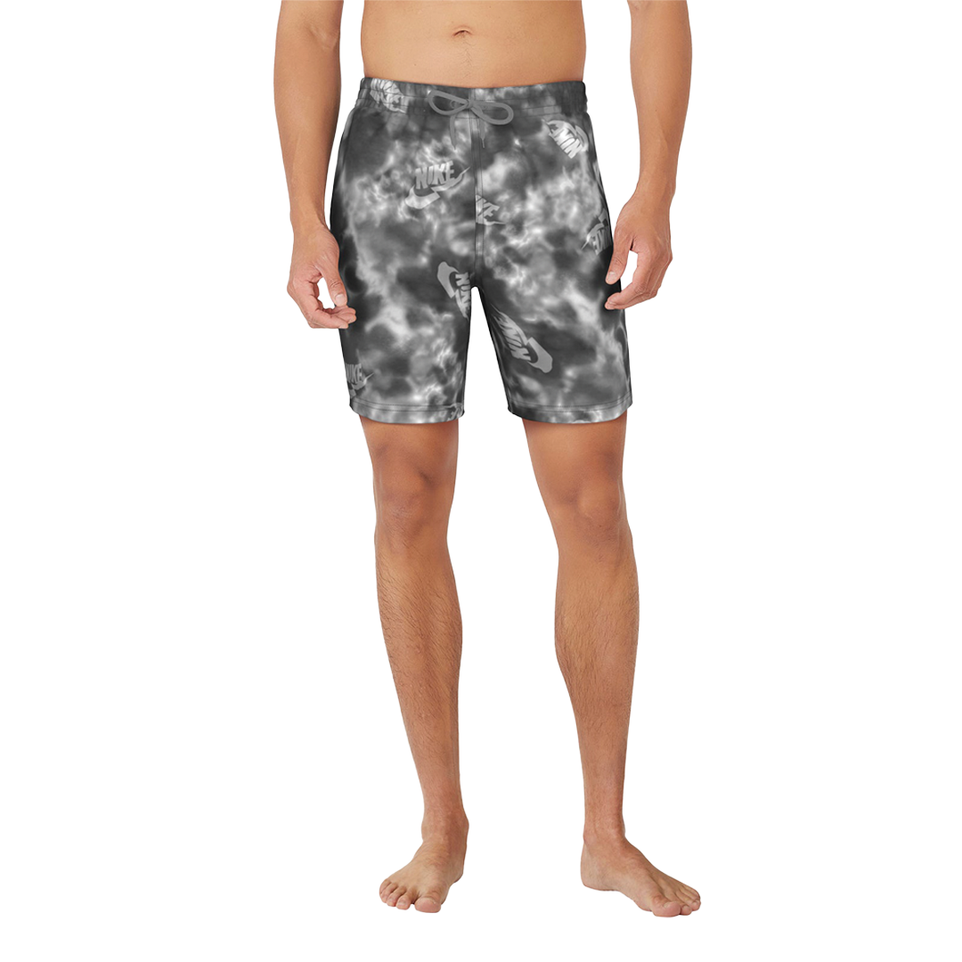 Person wearing tie-dye swim shorts on a white background