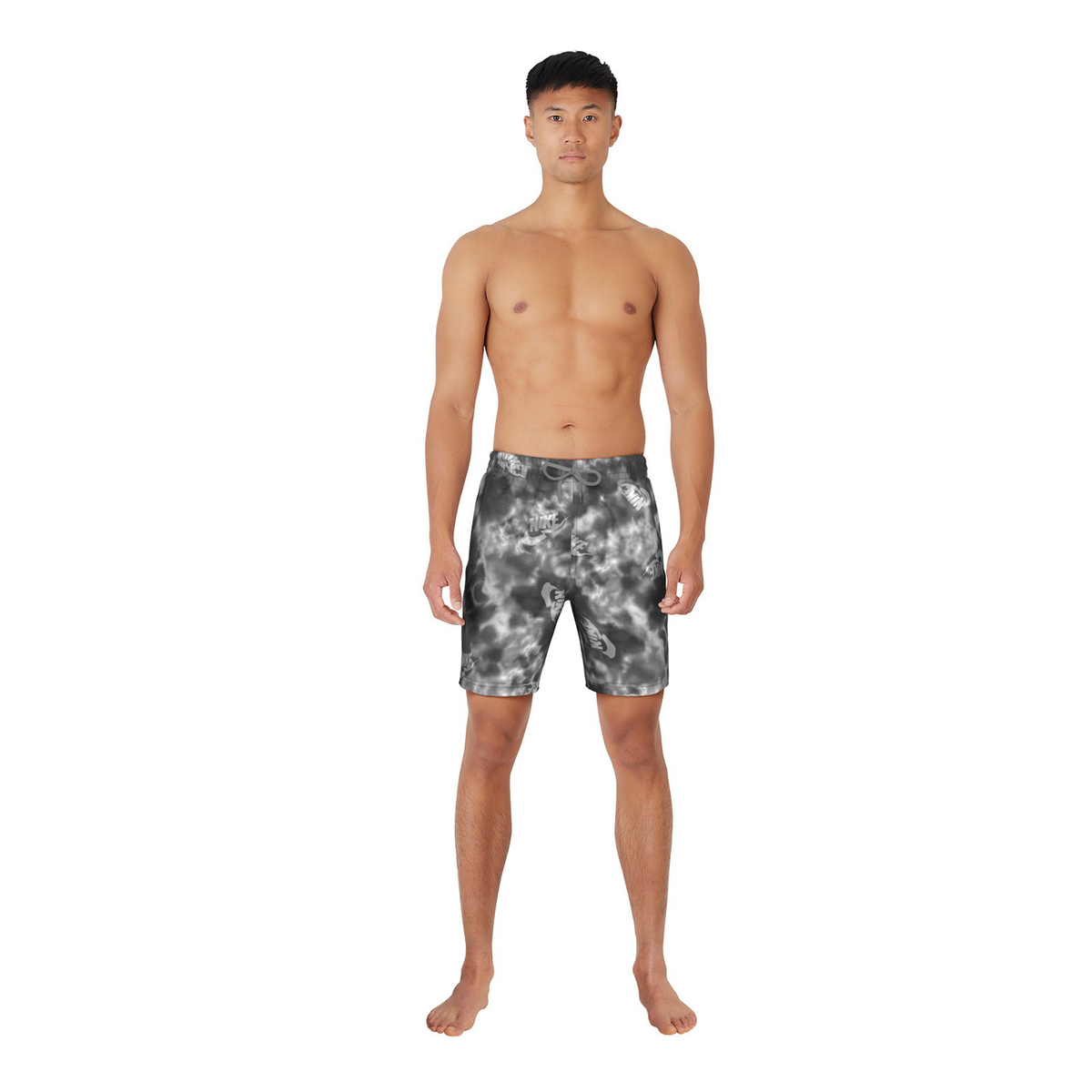 Man wearing black and gray tie-dye swim shorts on a white background