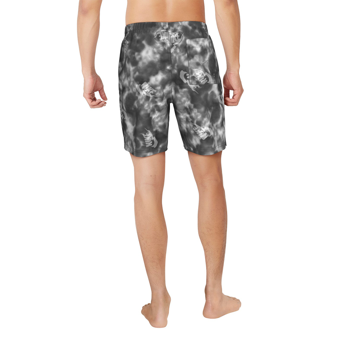Person wearing gray tie-dye shorts on a white background