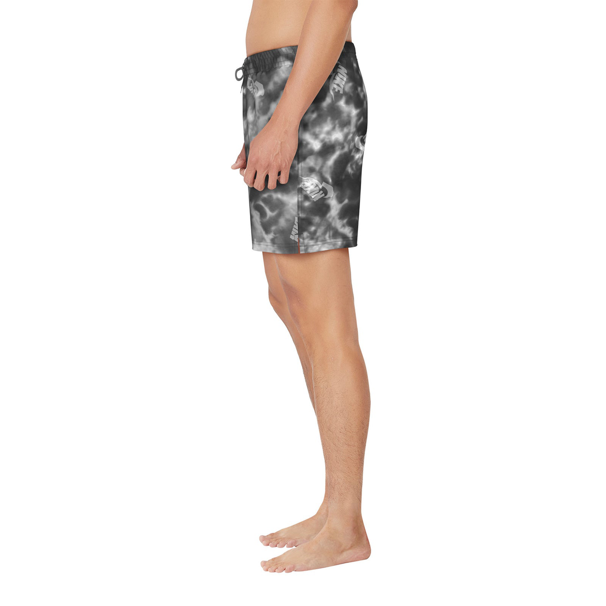 Person wearing tie-dye shorts on a white background