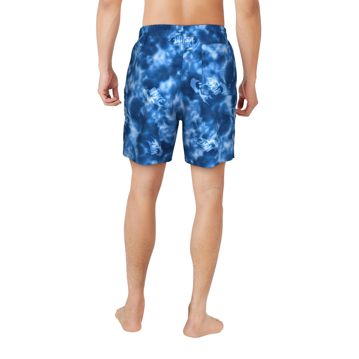 Blue tie-dye shorts worn by a person on a white background