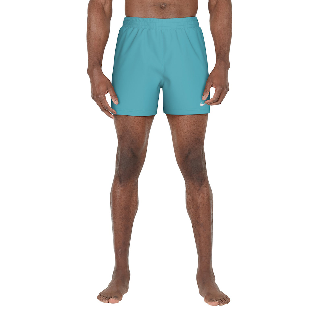 Person wearing teal shorts on a white background