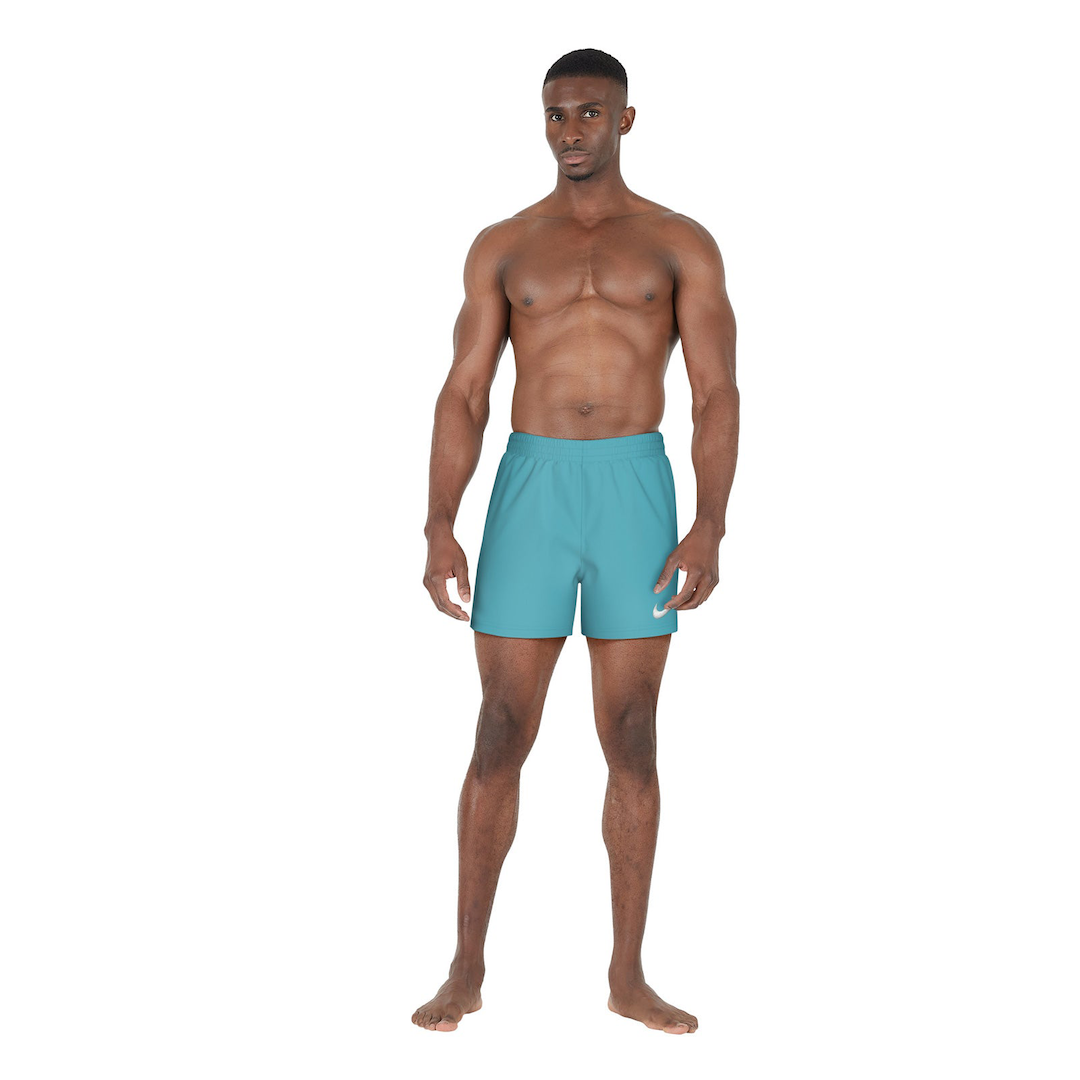 Man wearing teal swim shorts on a white background