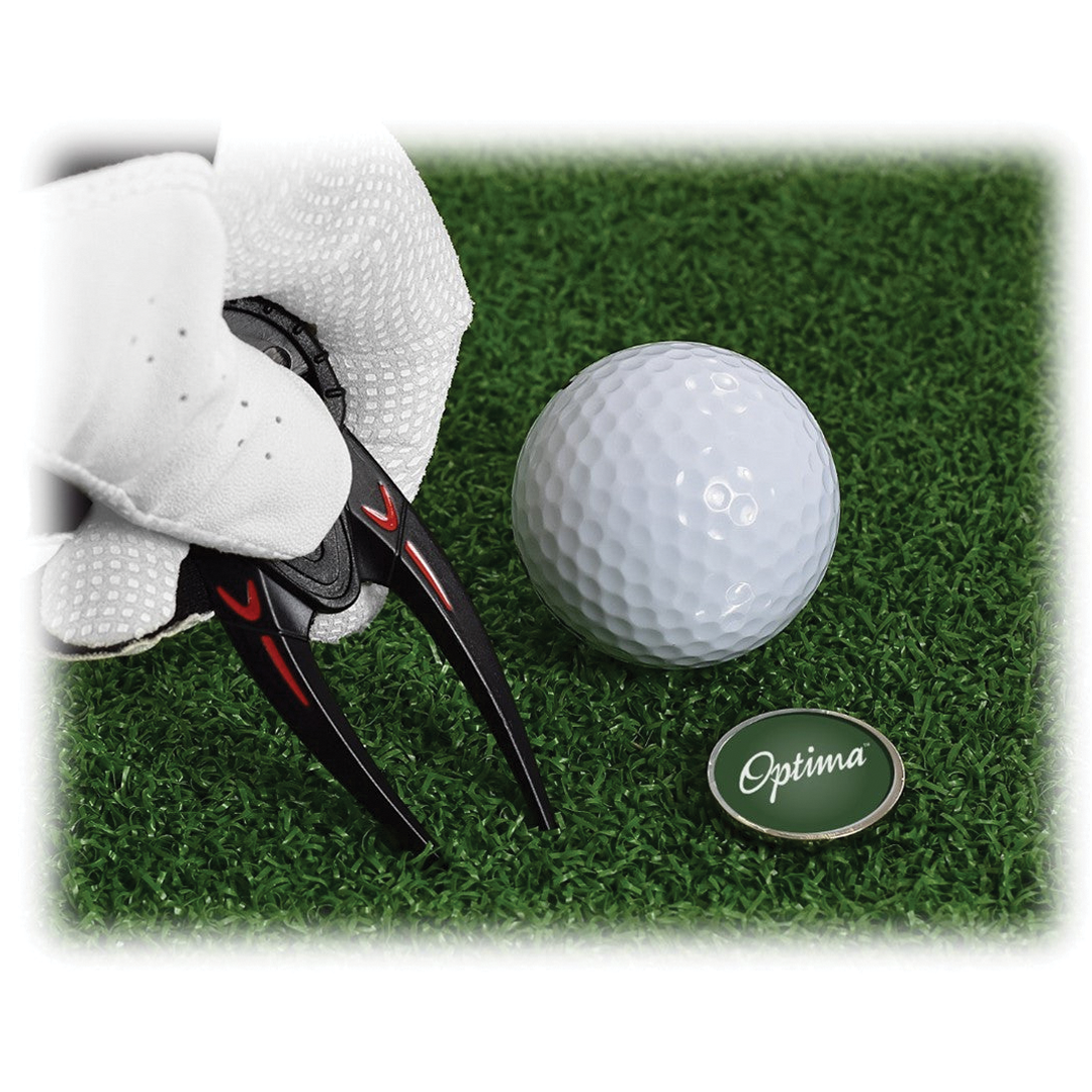 Golf ball with divot tool and glove on grass, featuring Optima branding.