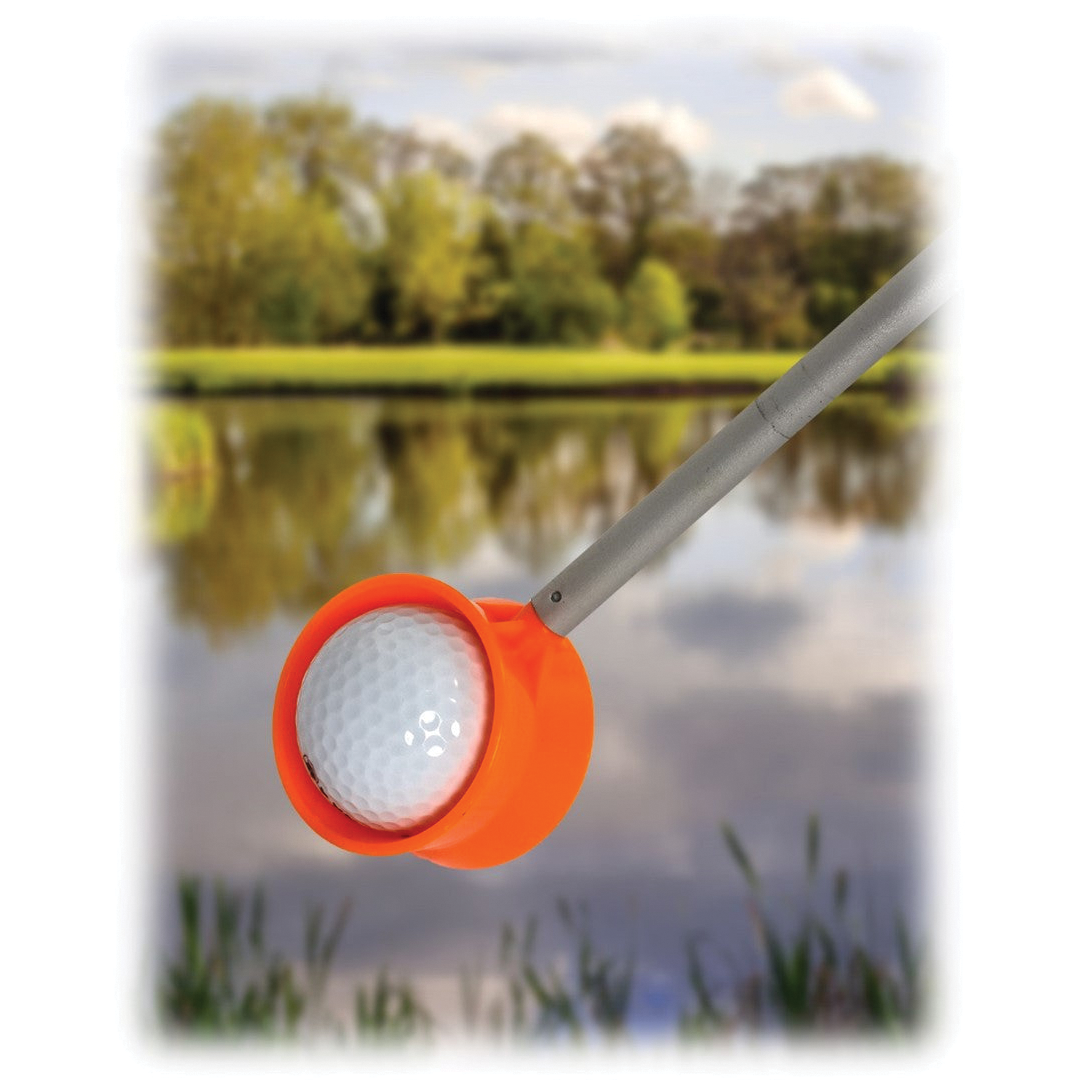 Golf ball on a stand with a scenic background of trees and water.